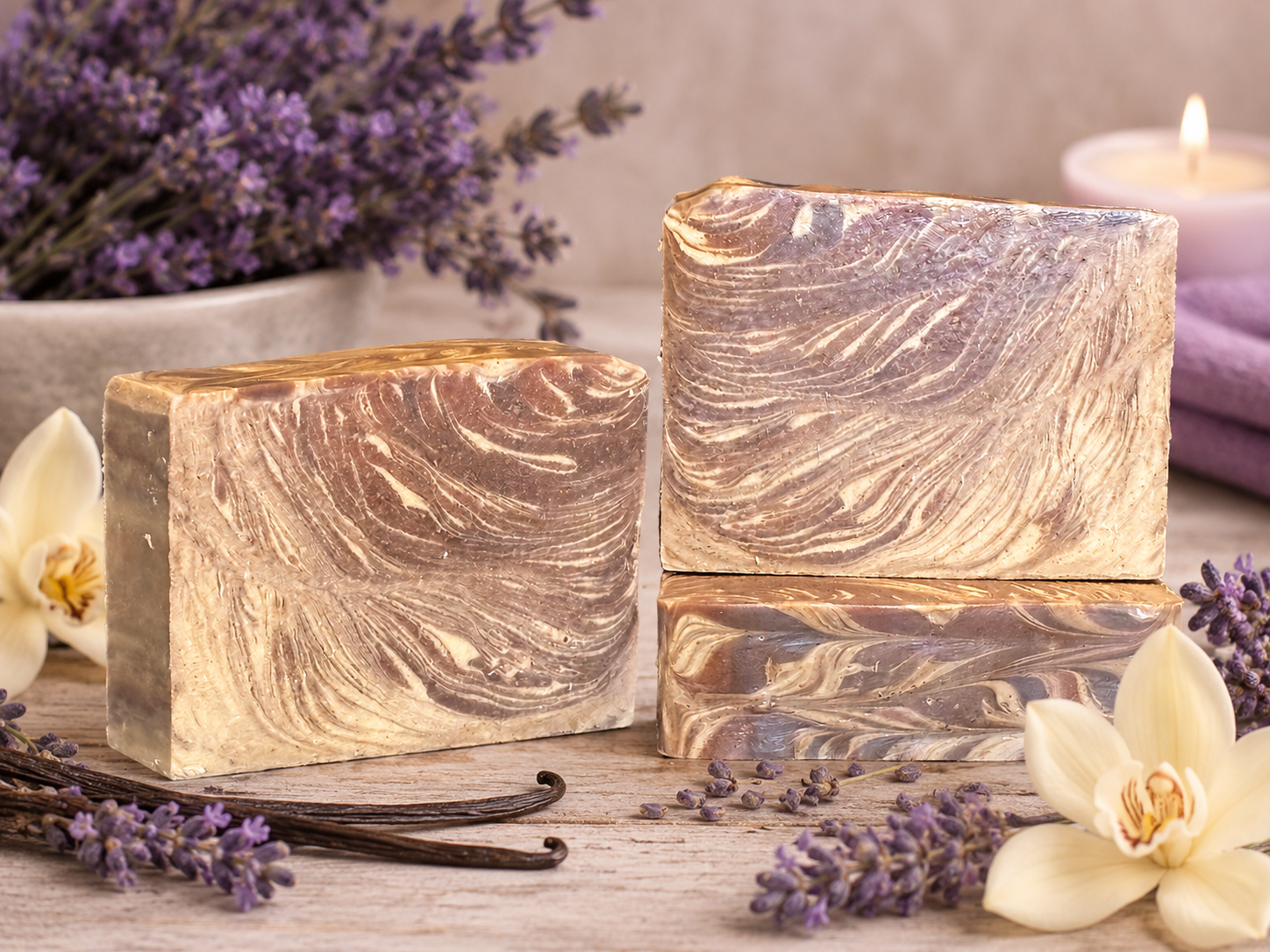 Marbled soaps on a surface with lavender and vanilla