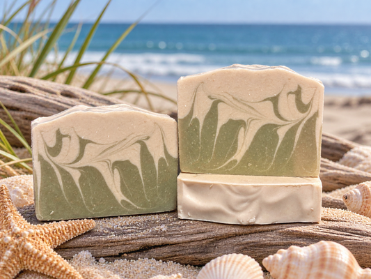 Three swirled green and white soaps with a beach themed background.