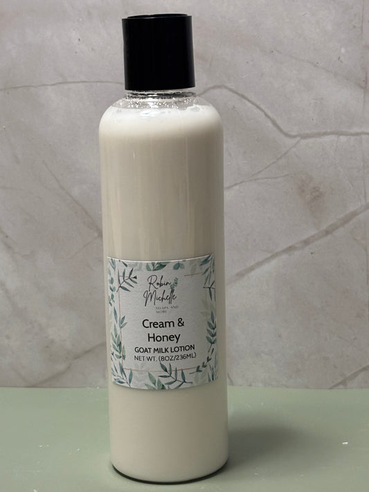 Bottle of Cream & Honey goat milk lotion on a marble surface
