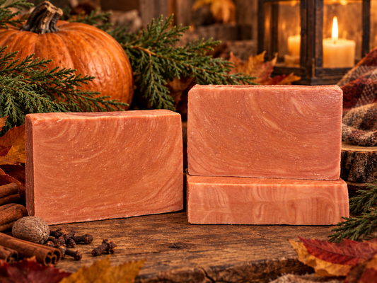 Three pink soaps on a wood piece with a Fall background.